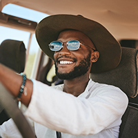 Guy smiling while driving a car